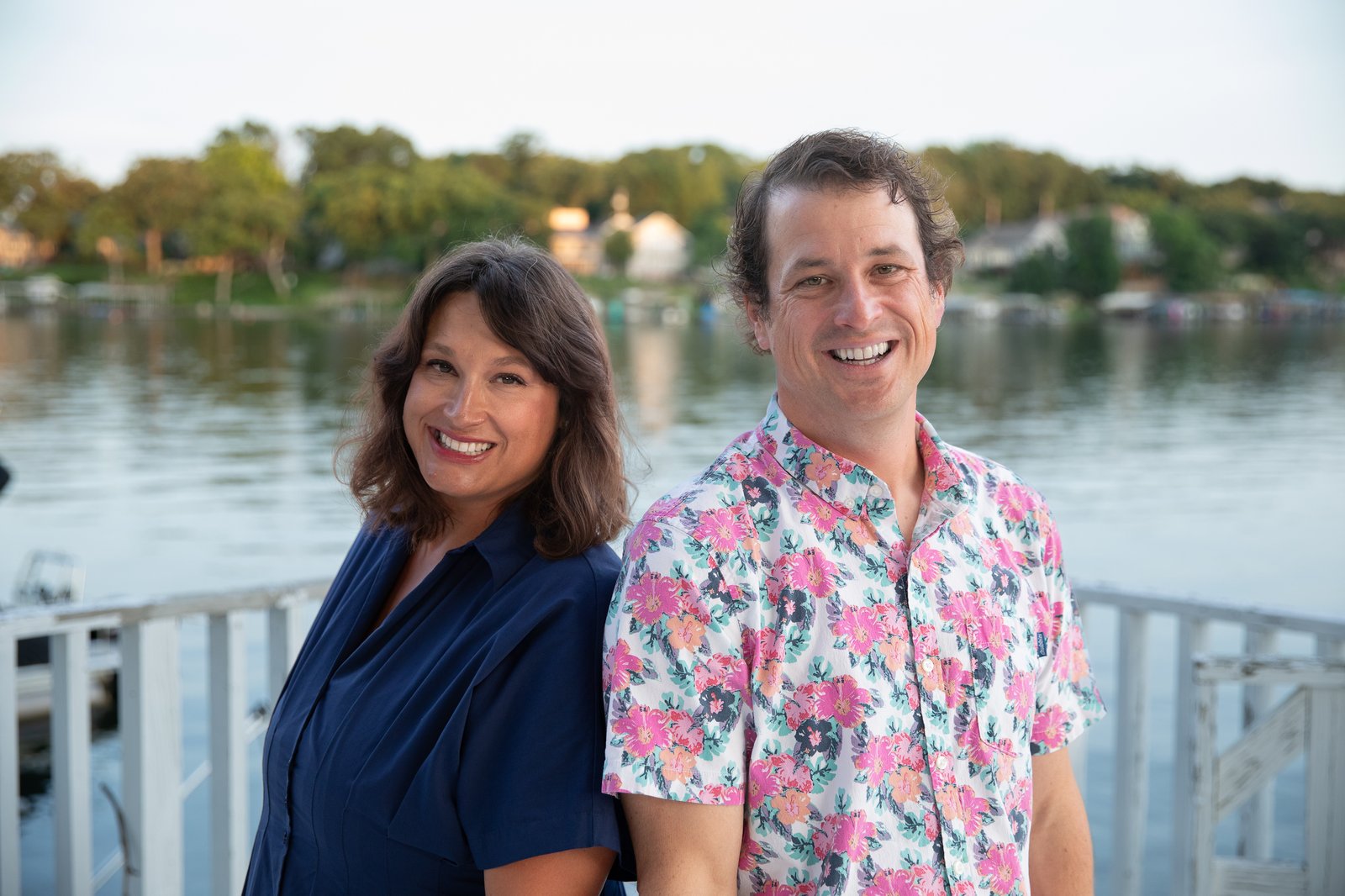 Laurie and Noel Runkle standing together on a Lake Lotawana dock at dusk