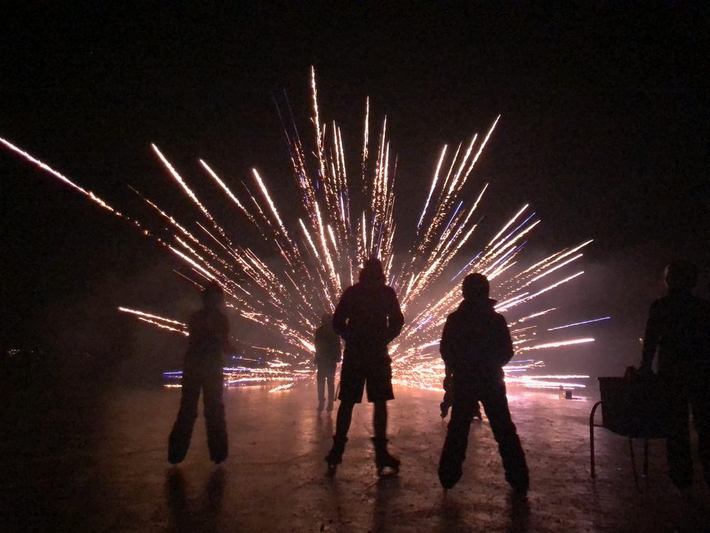 A crowd silhouetted against fireworks on the Fourth of July at Lake Lotawana