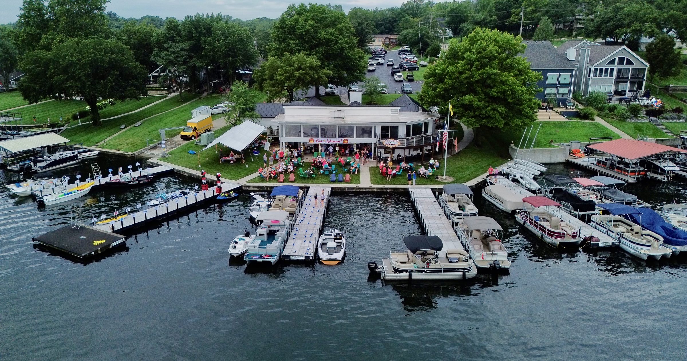 Aerial view of the Lake Lotawana marina and clubhouse, with docks and pontoon boats