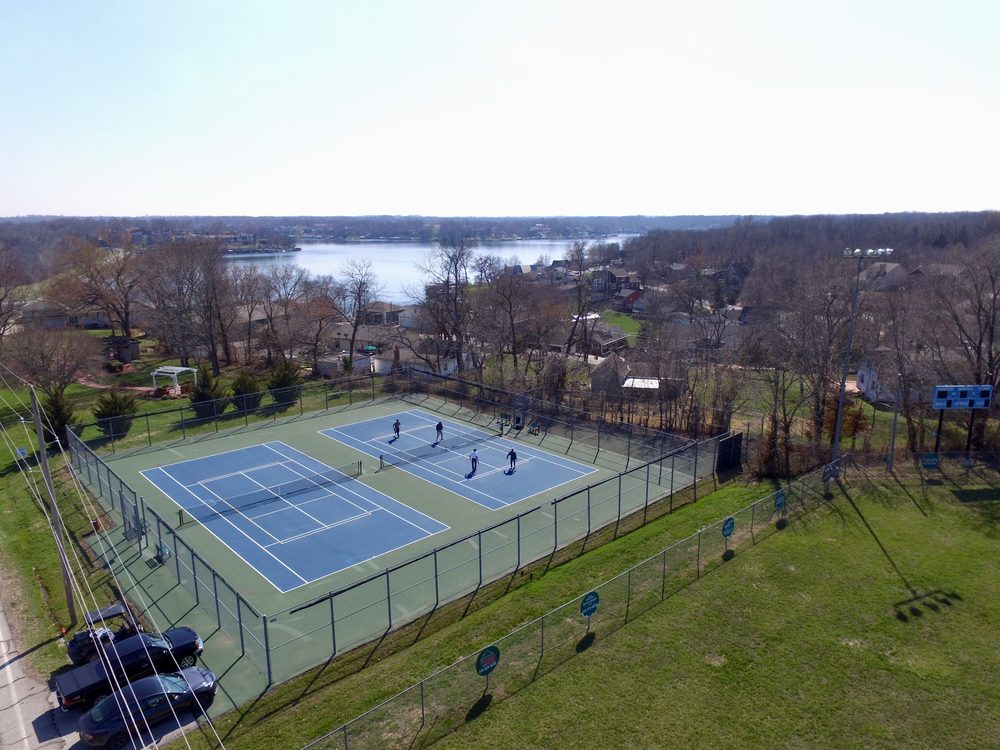 Aerial view of tennis and pickleball courts overlooking Lake Lotawana