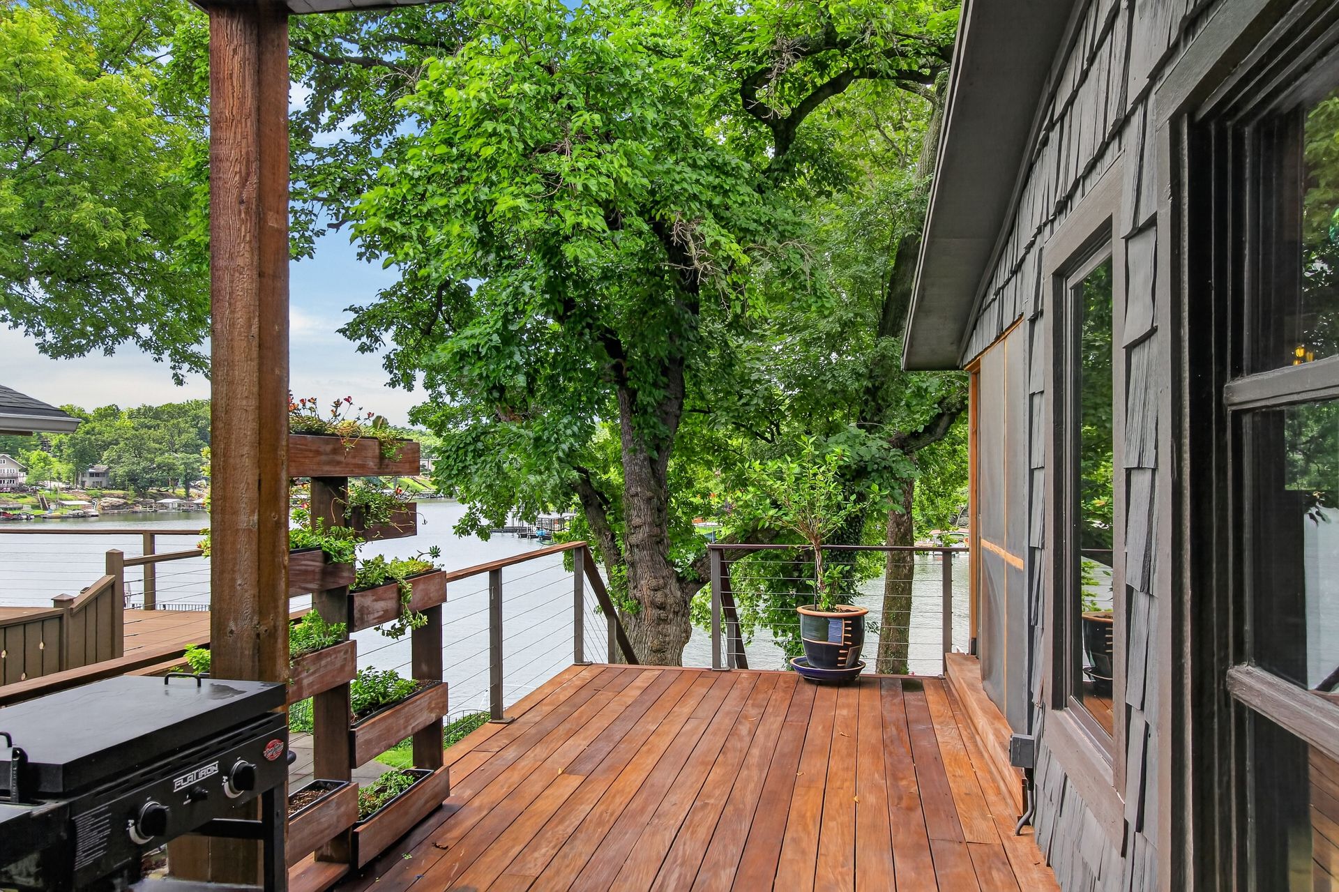 Back deck with grill and planter boxes overlooking the lake at 31 H Street, Lake Lotawana