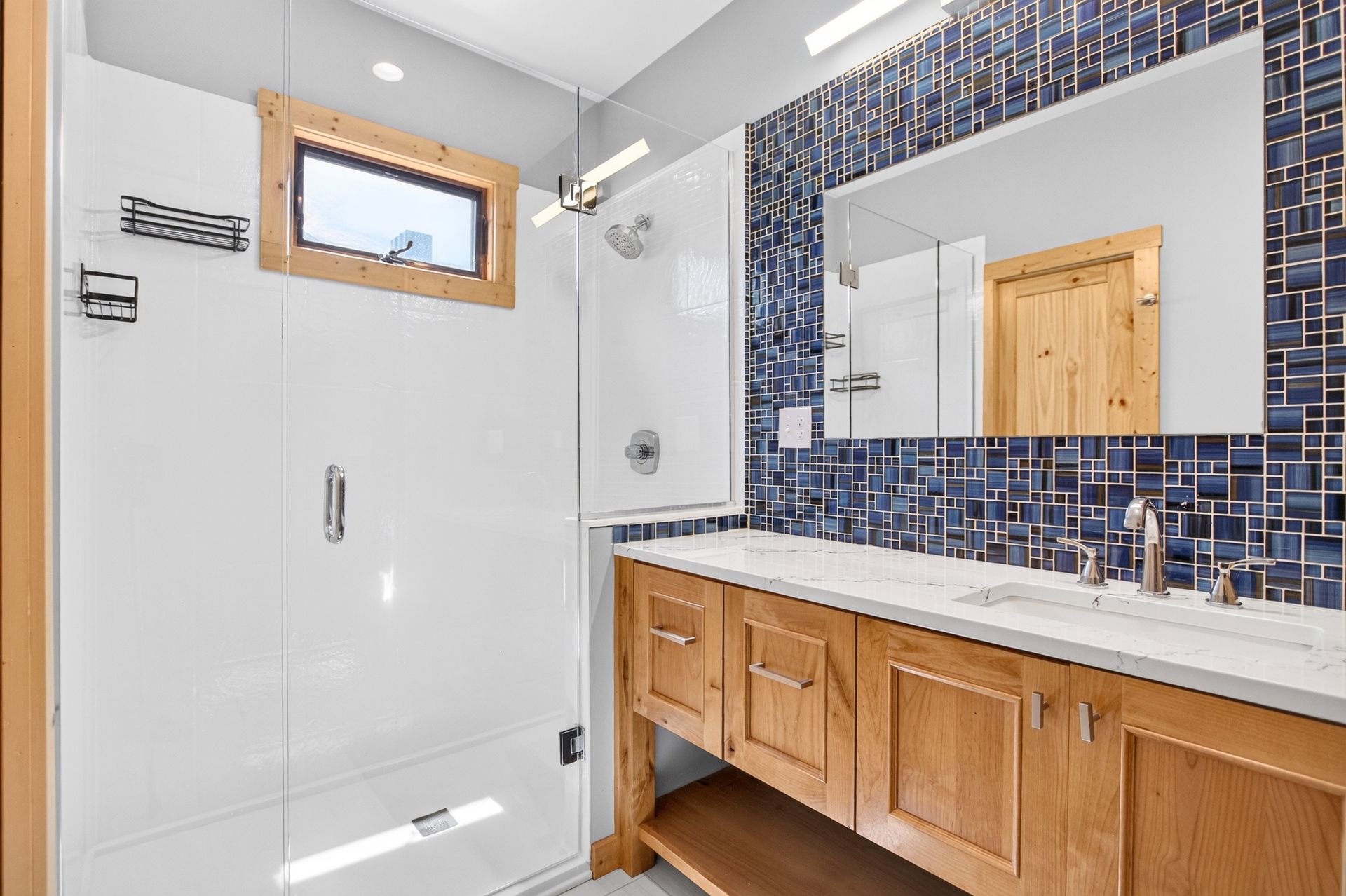Bathroom with blue mosaic tile and glass shower at 31 H Street, Lake Lotawana