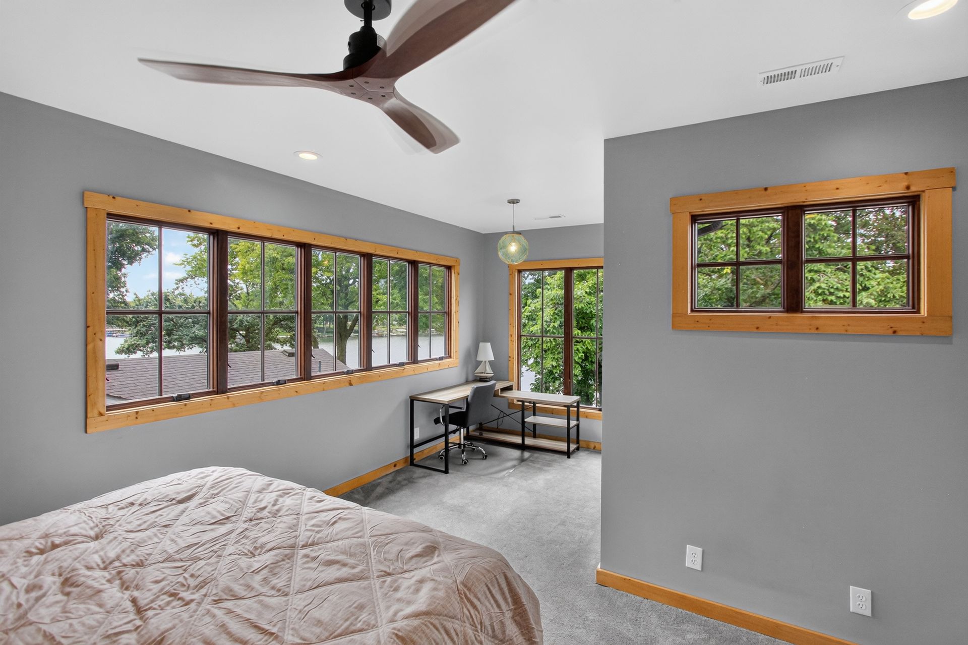 Bedroom with a wall of windows overlooking the lake at 31 H Street, Lake Lotawana