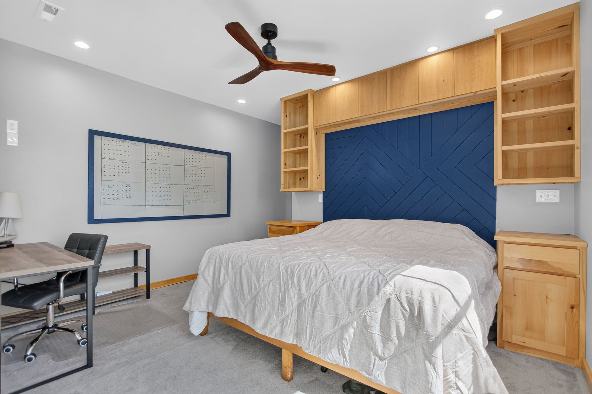 Upper-level bedroom suite with navy herringbone accent wall at 31 H Street, Lake Lotawana