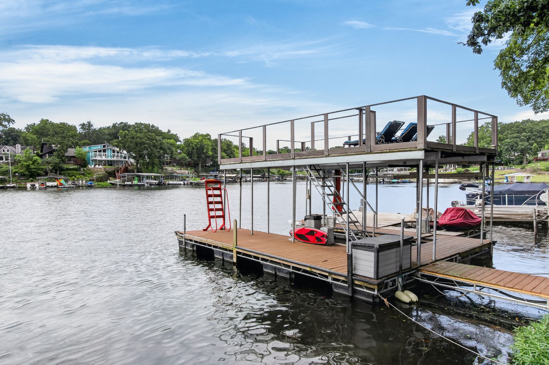 Covered boat lift and dock with upper lounge deck at 31 H Street, Lake Lotawana
