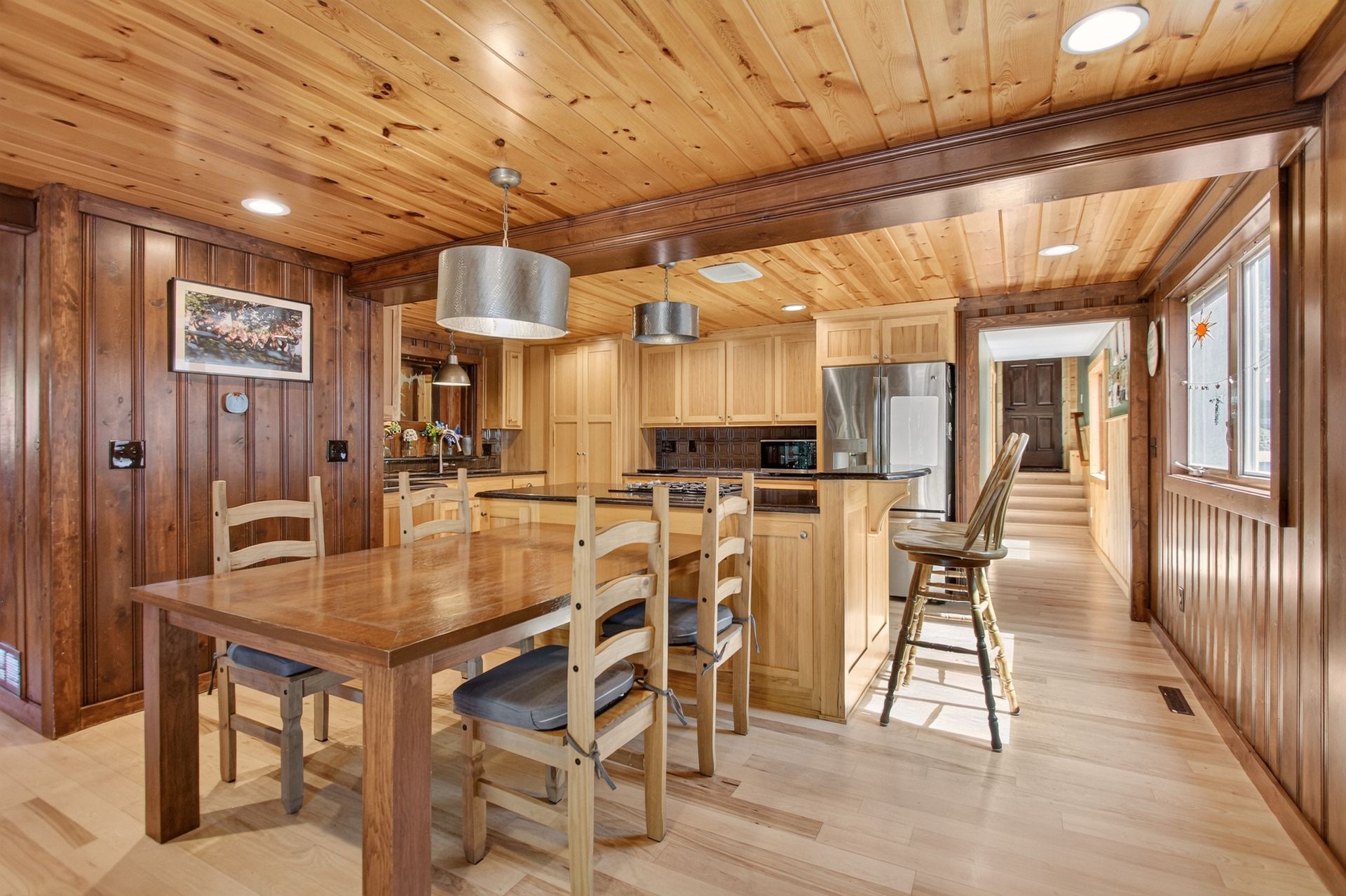 Dining room with farmhouse table adjacent to the kitchen at 31 H Street, Lake Lotawana