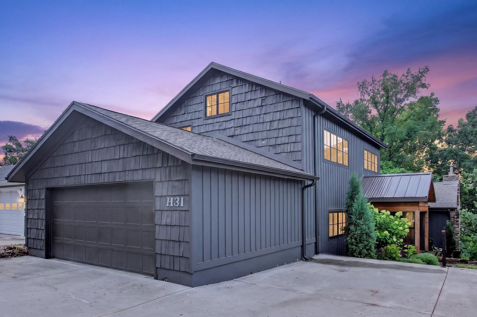Twilight exterior of 31 H Street with the H31 house number and covered entry, Lake Lotawana