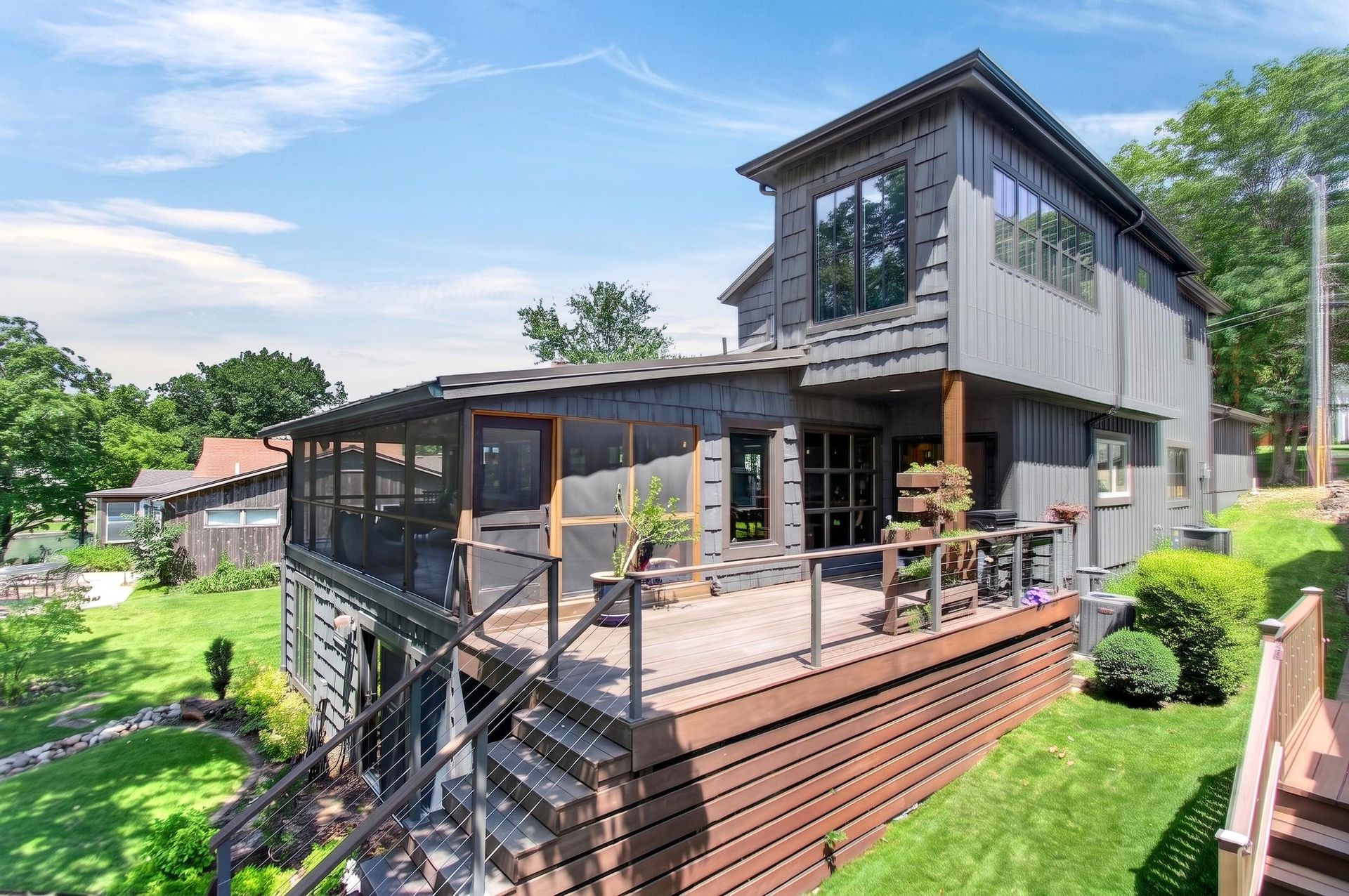 Rear exterior of 31 H Street showing the multi-level deck and screened porch, Lake Lotawana