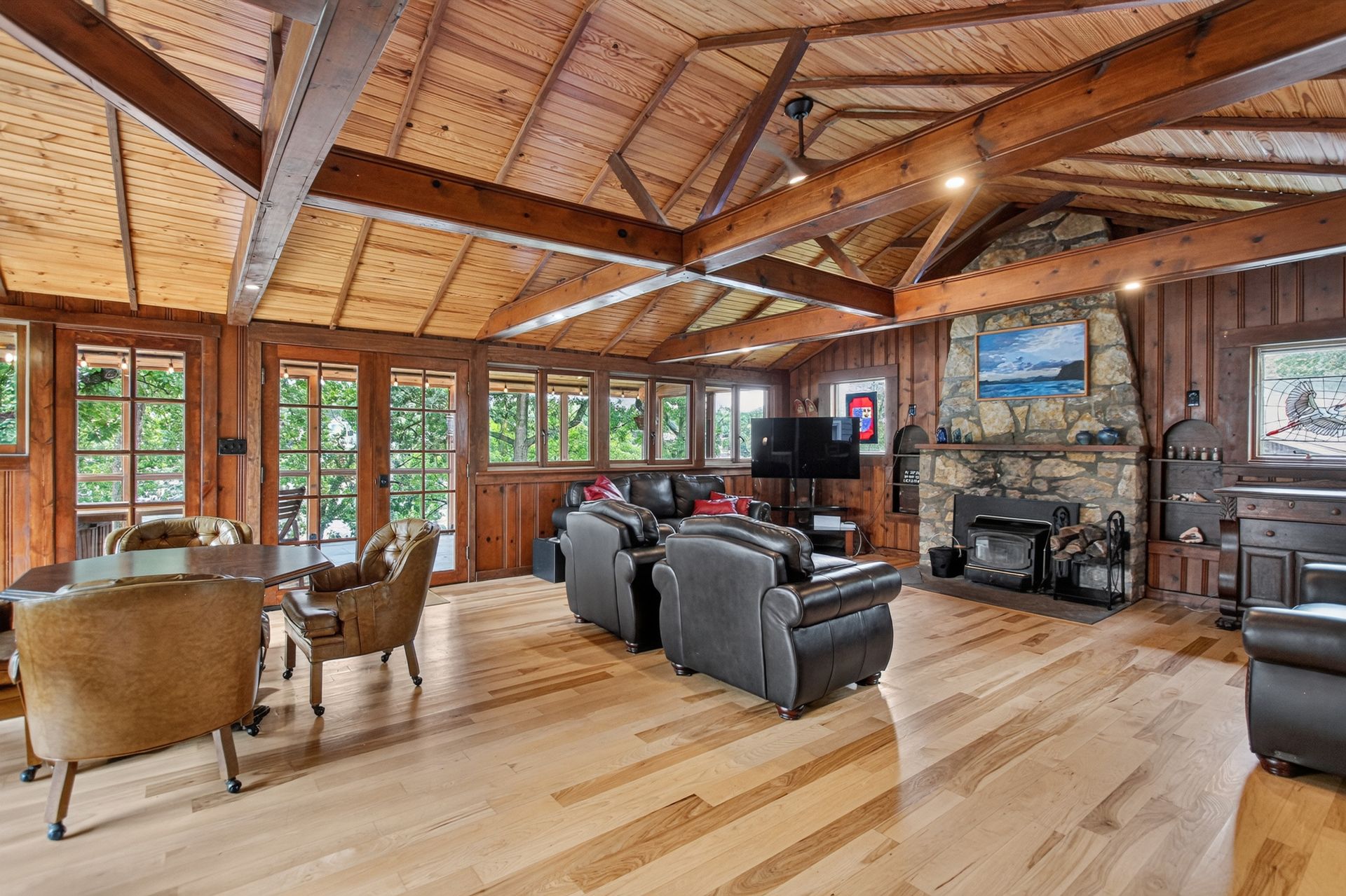 Living room with vaulted wood ceiling and stone fireplace at 31 H Street, Lake Lotawana
