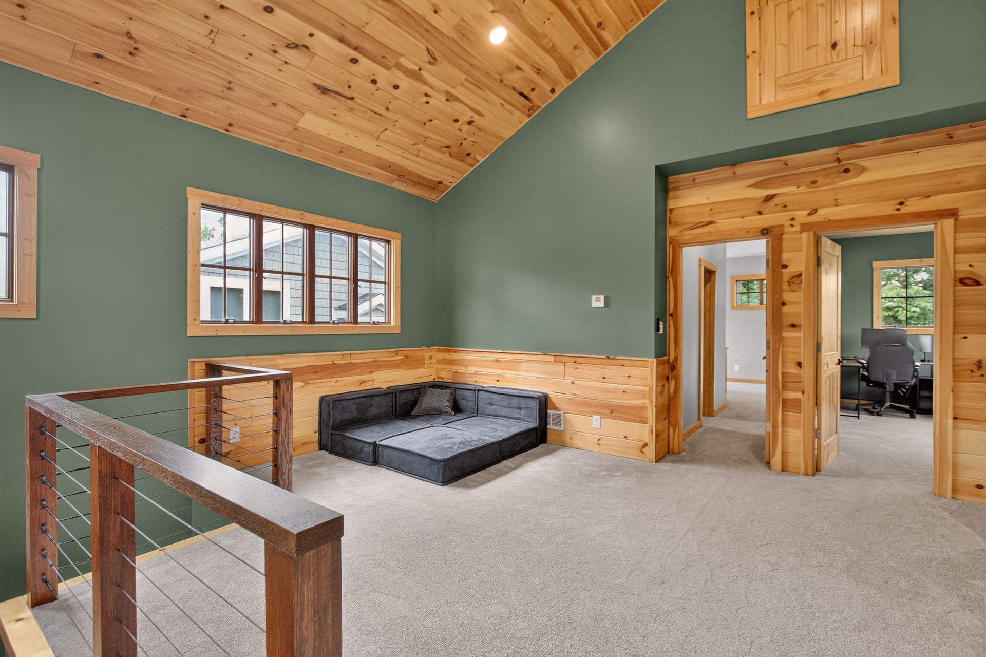 Upstairs loft sitting area with green accent wall and home office beyond at 31 H Street, Lake Lotawana