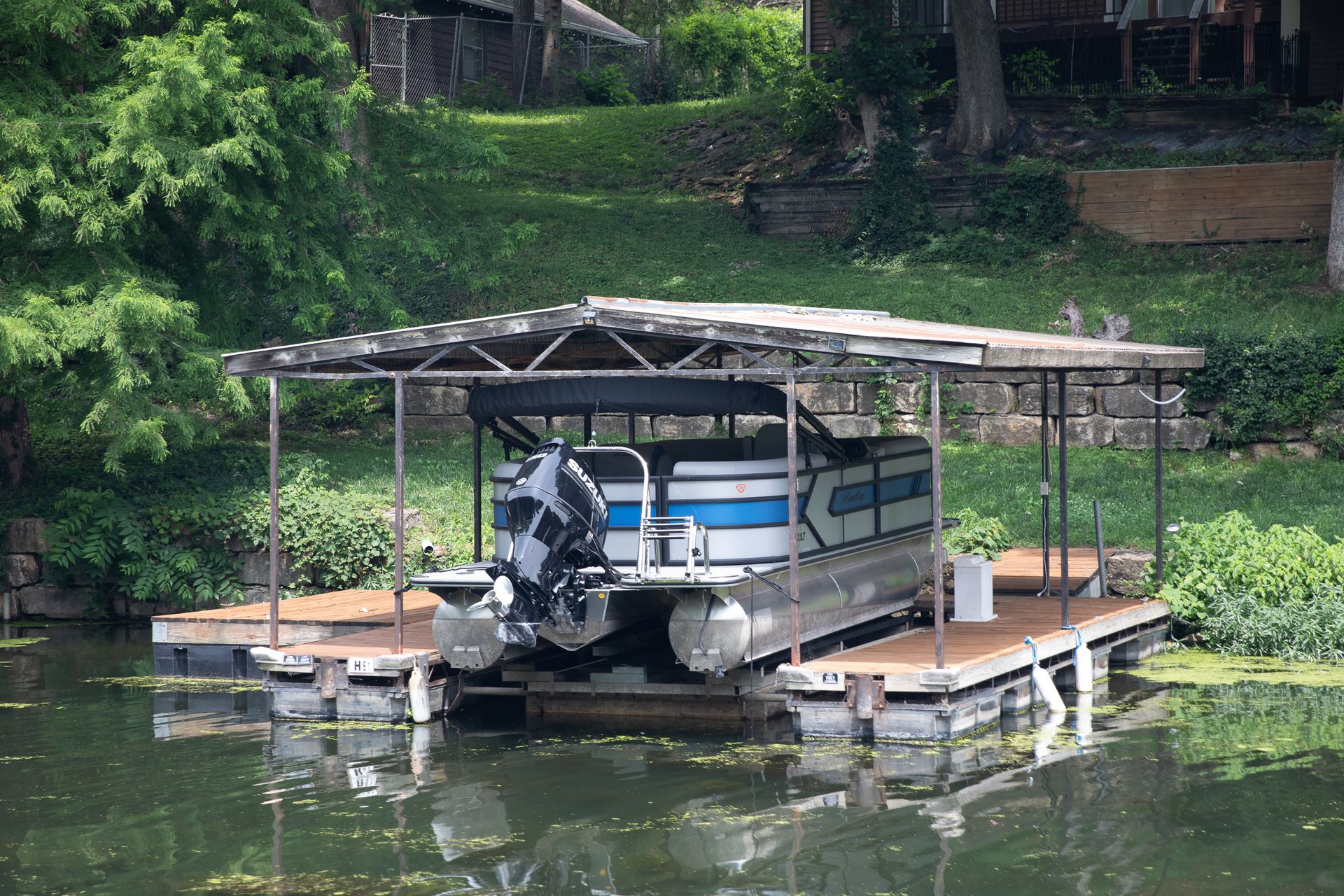 Covered boat dock and pontoon boat at 61 H Street, Lake Lotawana