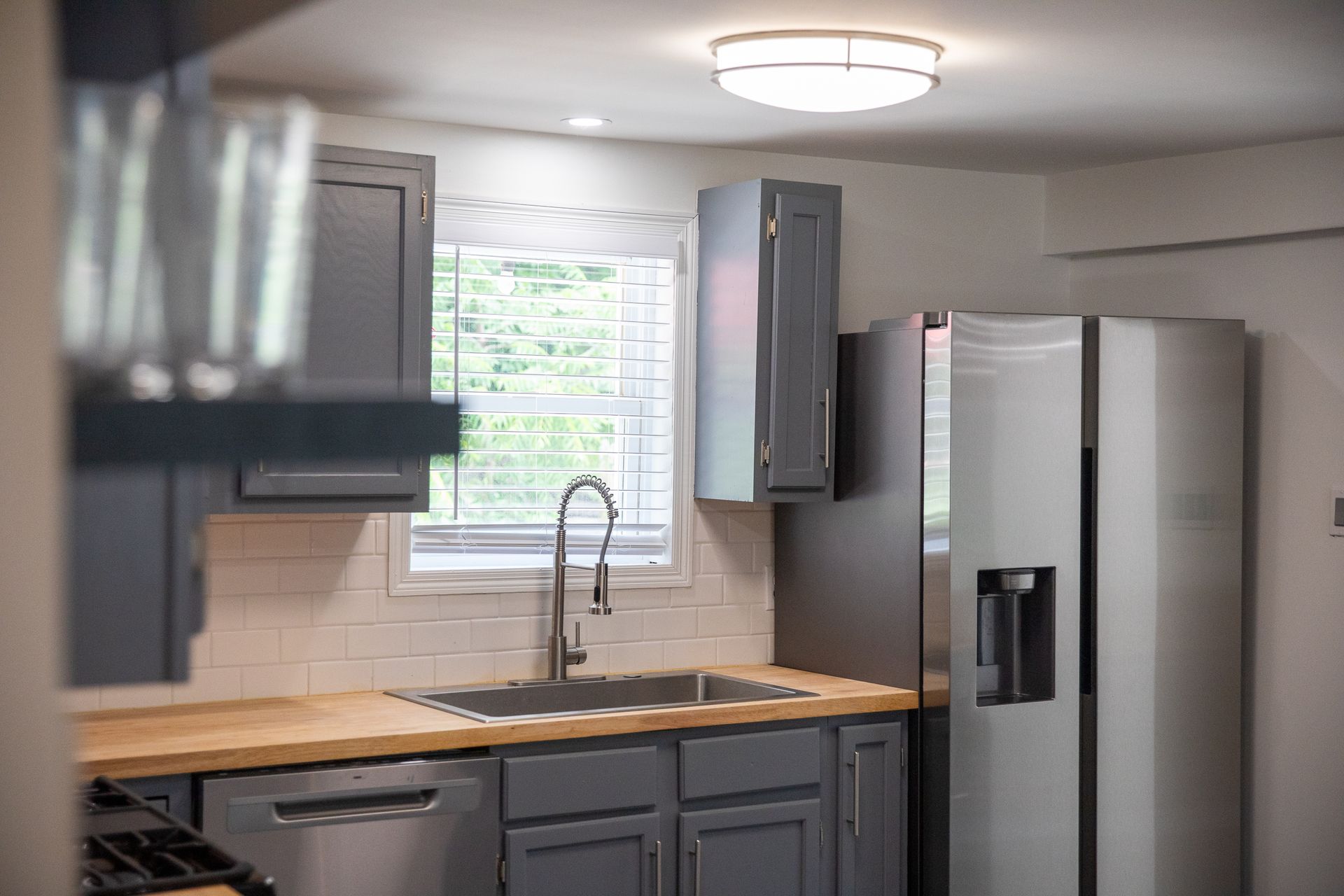 Remodeled kitchen with butcher block counters and stainless refrigerator at 61 H Street, Lake Lotawana